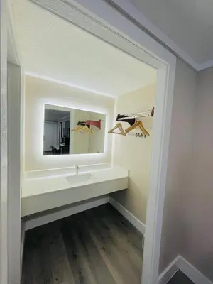 a bathroom with a sink and a mirror at Super 8 by Wyndham Kissimmee-Orlando in Kissimmee