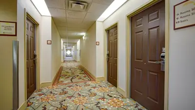 a hallway with a tile floor and a door at Galleria Palms Orlando - Free Theme Park Shuttles in Orlando