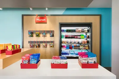 a grocery store with a refrigerator with drinks at avid hotels - Orlando International Airport by IHG in Orlando