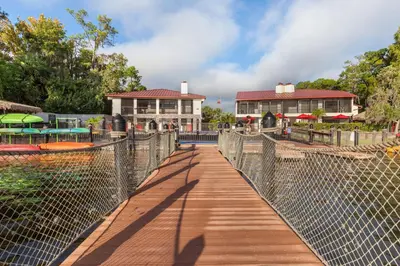 a wooden walkway leading to a resort with a building at Bryan's Spanish Cove in Orlando