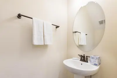 a bathroom with a sink and a mirror and towels at Blue Oasis Near Disney With Margaritaville Resort & Island H2O Access - 8049Sh in Orlando