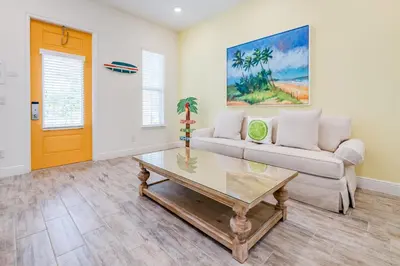 a living room with a couch and a coffee table at Key Lime Cabana Cottage Near Disney With Margaritaville Resort & Island H2O Access - 3062Kl in Orlando
