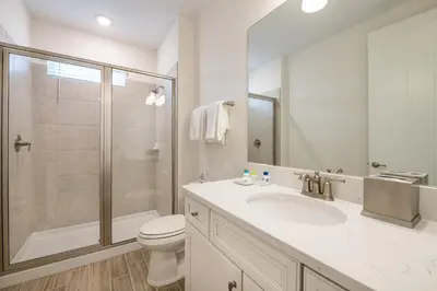 a bathroom with a toilet and a sink and a shower at Coral Waves Cottage With Private Pool Near Disney With Margaritaville Resort & Island H2O Access - 8040Sh in Orlando