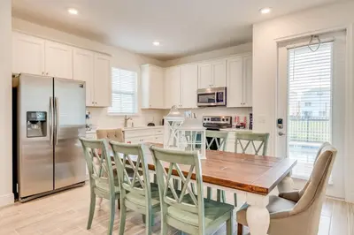 a kitchen with a table and chairs and a refrigerator at Coral Waves Cottage With Private Pool Near Disney With Margaritaville Resort & Island H2O Access - 8040Sh in Orlando