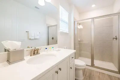 a white bathroom with a sink and a shower at Coral Waves Cottage With Private Pool Near Disney With Margaritaville Resort & Island H2O Access - 8040Sh in Orlando