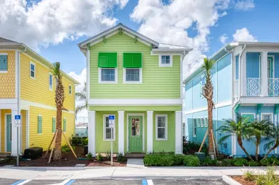 a row of houses with green and yellow at Playa Verde Cottage With Private Hot Tub Near Disney With Margaritaville Resort & Island H2O Access - 8028Dr in Orlando