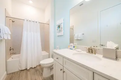 a bathroom with a sink and a toilet and a shower at Sun Baked Cottage With Hot Tub Near Disney With Margaritaville Resort & Island H2O Access - 8089Dr in Orlando