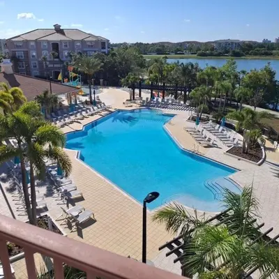 a large swimming pool with lounge chairs and a resort at 13-403 Your Vista Cay Home in Orlando