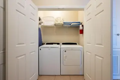 a small laundry room with a washer and dryer at 13-403 Your Vista Cay Home in Orlando