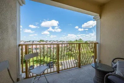 a view from a balcony with a chair and a table at 13-403 Your Vista Cay Home in Orlando