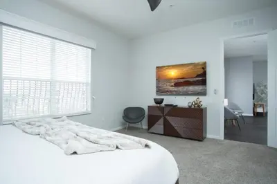 a white bedroom with a bed and a large window at 2-403 Your Vista Cay Condo in Orlando