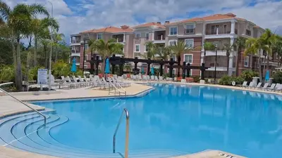 a large swimming pool with chairs and condos at 2-403 Your Vista Cay Condo in Orlando