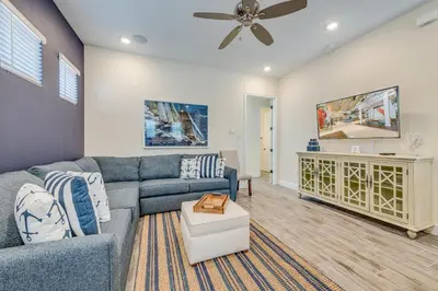 a living room with a couch and a ceiling fan at Sandy Cottage! 3 Miles From Disney With Margaritaville Resort & Island H2O Access - 8080Dr in Orlando