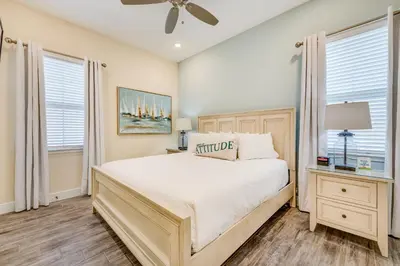 a bedroom with a large bed and two windows at Sandy Cottage! 3 Miles From Disney With Margaritaville Resort & Island H2O Access - 8080Dr in Orlando