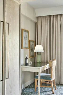 a desk with a lamp and a chair in a room at The Inn at Celebration, Autograph Collection in Orlando