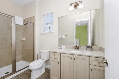 a bathroom with a toilet and a sink and a shower at Teenie Bikini Cottage With Private Hot Tub Near Disney With Margaritaville Resort & Island H2O Access - 3071Kl in Orlando