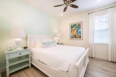 a white bedroom with a bed and a ceiling fan at Bikini Bay Cottage With Private Pool Near Disney And Margaritaville Resort & Island H20 Waterpark Access - 3094Ph in Orlando