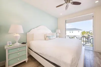 a bedroom with a bed and a window with a balcony at Bikini Bay Cottage With Private Pool Near Disney And Margaritaville Resort & Island H20 Waterpark Access - 3094Ph in Orlando