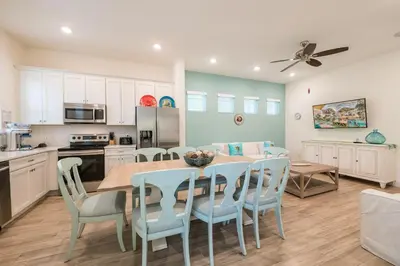 a kitchen and dining room with a table and chairs at Another Day In Paradise Cottage With Private Hot Tub Near Disney With Margaritaville Resort & Island H2O Access - 8024Dr in Orlando