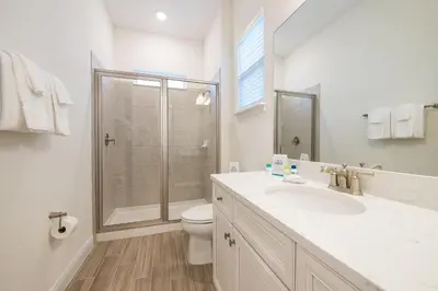 a bathroom with a shower and a sink and a toilet at Another Day In Paradise Cottage With Private Hot Tub Near Disney With Margaritaville Resort & Island H2O Access - 8024Dr in Orlando