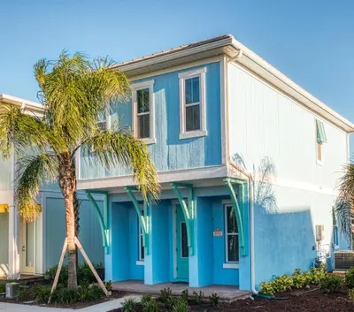 a blue house with a palm tree in front of it at Lovely Cottage 3 Miles From Disney W Hot Tub And Margaritaville Resort & Island H2O Access - 8092Dr in Orlando