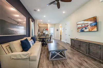 a living room with a couch and a table at Lovely Cottage 3 Miles From Disney W Hot Tub And Margaritaville Resort & Island H2O Access - 8092Dr in Orlando