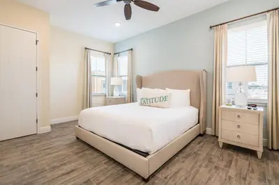 a white bedroom with a bed and a ceiling fan at Lovely Cottage 3 Miles From Disney W Hot Tub And Margaritaville Resort & Island H2O Access - 8092Dr in Orlando