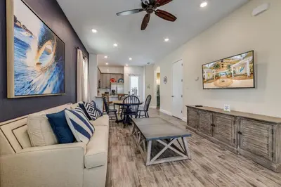 a living room with a couch and a ceiling fan at Breezy Cottage With Hot Tub Near Disney With Margaritaville Resort & Island H2O Access - 8069Dr in Orlando