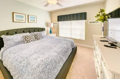 a bedroom with a bed and a desk at Storey Lake 4b3b town home with private pool in Kissimmee