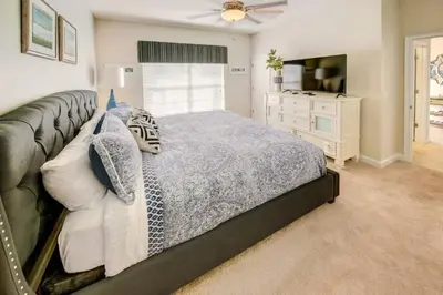 a bedroom with a bed and a television in it at Storey Lake 4b3b town home with private pool in Kissimmee