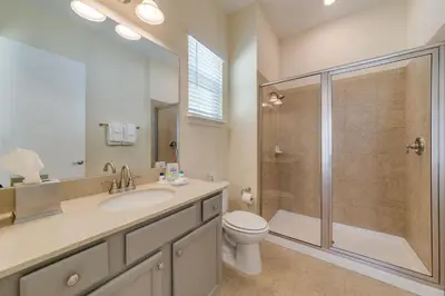 a bathroom with a toilet sink and a shower at Cozy Cottage With Hot Tub Near Disney With Margaritaville Resort & Island H2O Access - 8056Dr in Orlando