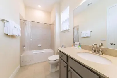 a bathroom with a sink and a toilet and a shower at Dreamy Cottage With Private Hot Tub Near Disney With Margaritaville Resort & Island H2O Access - 3020La in Orlando