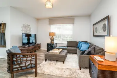 a living room with a couch and a tv at Orlando Escape in Orlando