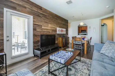 a living room with a wooden accent wall at Orlando Escape in Orlando