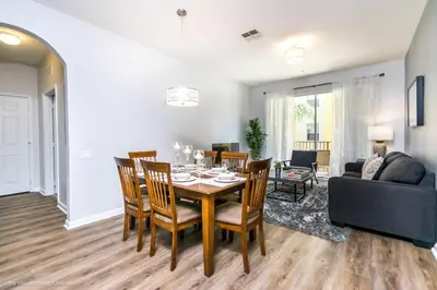 a dining room and living room with a table and chairs at Orlando Escape in Orlando
