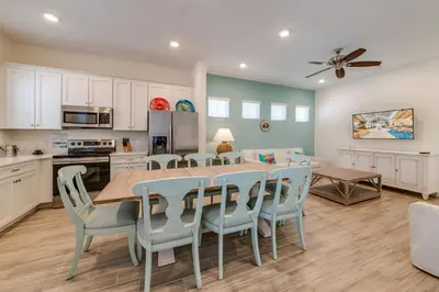 a kitchen and dining room with a table and chairs at Tropical Oasis Cottage With Private Hot Tub Near Disney With Margaritaville Resort & Island H2O Access - 3021La in Orlando