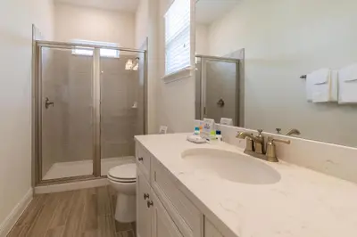 a bathroom with a shower and a sink and a toilet at Tropical Oasis Cottage With Private Hot Tub Near Disney With Margaritaville Resort & Island H2O Access - 3021La in Orlando