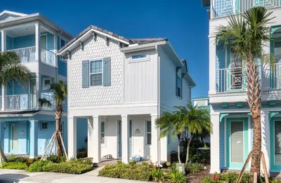 a house with palm trees in front of it at Nautical Cottage With Private Hot Tub Near Disney With Margaritaville Resort & Island H2O Access - 3044Sr in Orlando