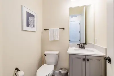 a bathroom with a white toilet and a sink at Nautical Cottage With Private Hot Tub Near Disney With Margaritaville Resort & Island H2O Access - 3044Sr in Orlando