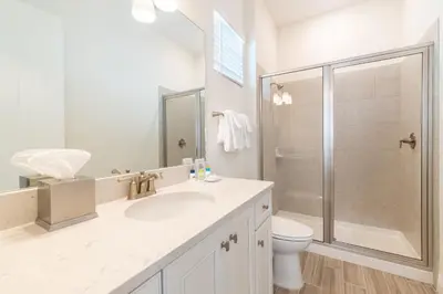 a bathroom with a toilet and a sink and a shower at Waterfront Cottage With Private Pool Near Disney And Margaritaville Resort & Island H20 Access - 7985Su in Orlando