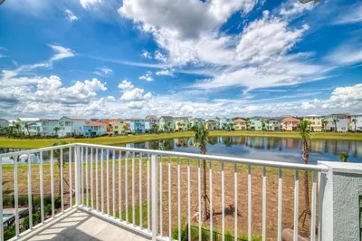 a view from the balcony of a apartment complex with a body of water at Spacious Cottage With Private Pool Near Disney With Margaritaville Resort & Island H2O Access - 8009Su in Orlando