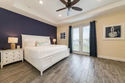 a bedroom with a white bed and a ceiling fan at Bon Voyage Cottage With Private Pool Near Disney With Margaritaville Resort & Island H2O Access - 8045Su in Orlando
