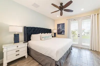 a bedroom with a bed and a ceiling fan at Bon Voyage Cottage With Private Pool Near Disney With Margaritaville Resort & Island H2O Access - 8045Su in Orlando