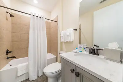 a bathroom with a toilet and a sink and a shower at Bon Voyage Cottage With Private Pool Near Disney With Margaritaville Resort & Island H2O Access - 8045Su in Orlando