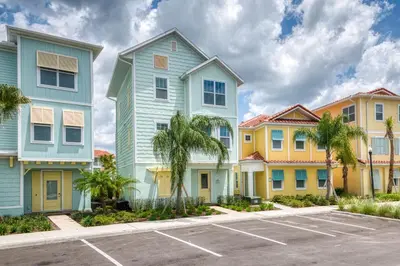 a row of colorful houses in a parking lot at Bon Voyage Cottage With Private Pool Near Disney With Margaritaville Resort & Island H2O Access - 8045Su in Orlando