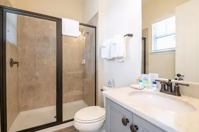 a bathroom with a shower and a toilet and a sink at Casa Del Mar Cottage Near Disney With Margaritaville Resort & Island H2O Access - 8009Ff in Orlando