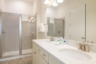 a bathroom with two sinks and a shower at Livin In Paradise Cottage With Private Hot Tub Near Disney With Margaritaville Resort & Island H2O Access - 8076Dr in Orlando