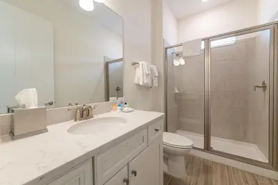 a bathroom with a toilet and a sink and a shower at We Be Jammin Cottage With Private Hot Tub Near Disney With Margaritaville Resort & Island H2O Access - 8020Dr in Orlando