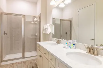 a bathroom with two sinks and a shower at Island Time Cottage With Hot Tub Near Disney With Margaritaville Resort & Island H2O Access - 8040Su in Orlando
