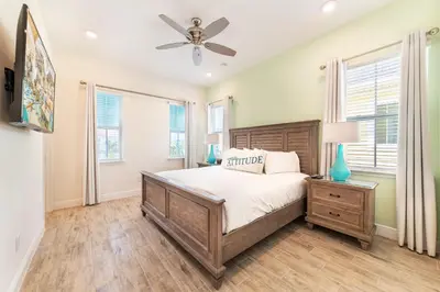 a bedroom with a bed and a ceiling fan at Island Time Cottage With Hot Tub Near Disney With Margaritaville Resort & Island H2O Access - 8040Su in Orlando